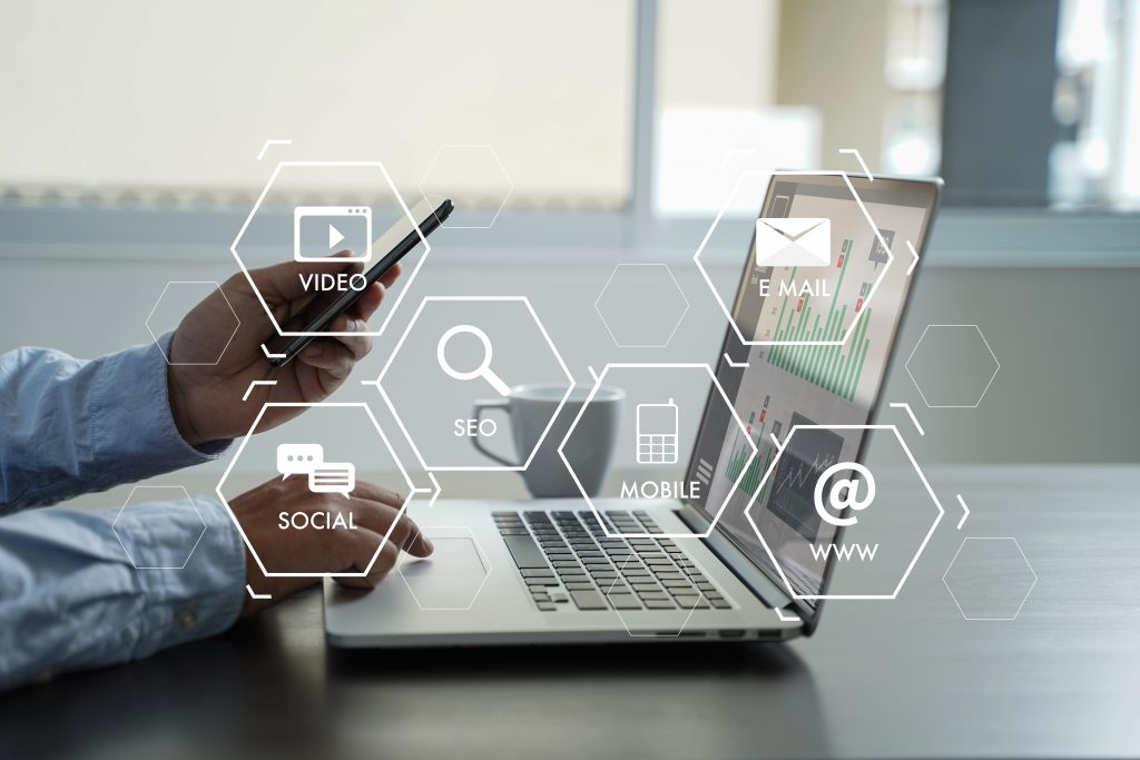 Imagen con marcas de agua y una persona con portatil y un cafe